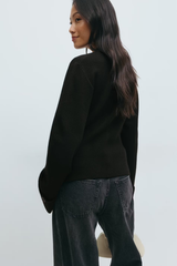 achterkant zwarte cardigan met subtiele manchetdetails