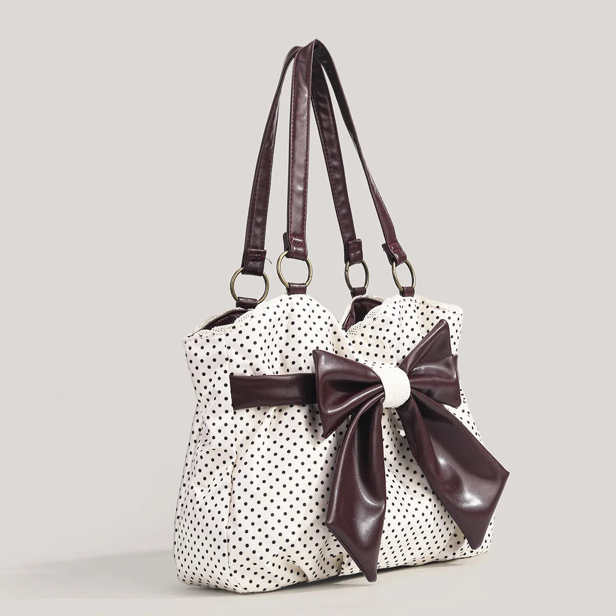 witte schoudertas met zwarte stippen en grote bruine strik dames