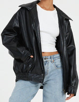 oversized zwarte leren jas met elastische taille, gedragen met wijde jeans