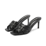 zwarte leren hakslippers met open neus