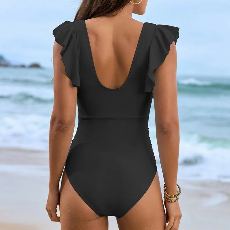 achterkant van zwarte monokini met open rug en hoge uitsnijding