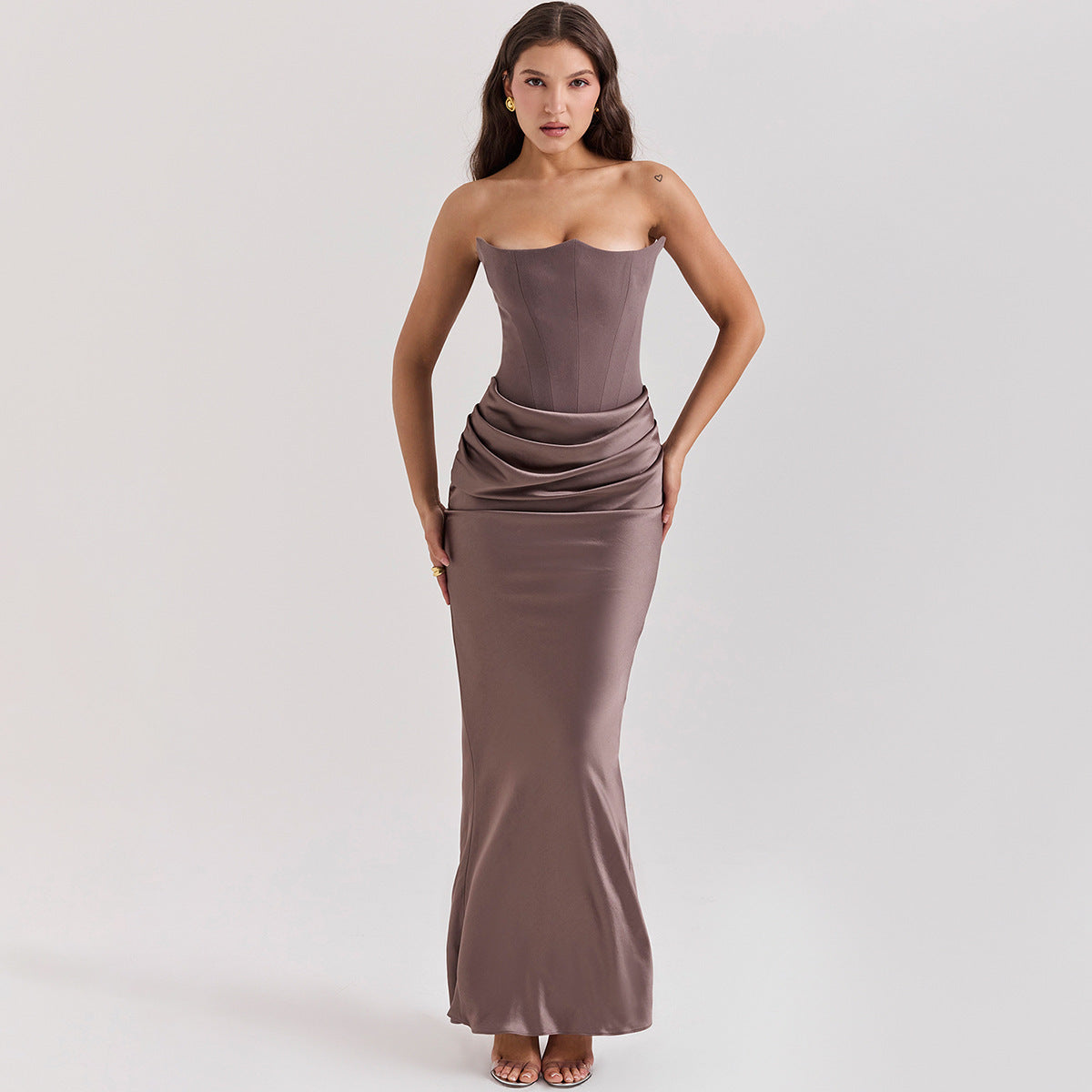 De Radiant™ Maxi Jurk is een elegante strapless avondjurk, verkrijgbaar in meerdere kleuren. Met een strakke pasvorm, gestructureerde buste en verfijnde drapering is deze jurk perfect voor formele gelegenheden, gala's en speciale evenementen. De satijnen glans voegt een vleugje luxe toe, terwijl de ritssluiting aan de achterkant zorgt voor een perfecte pasvorm. Combineer met hakken en subtiele sieraden voor een tijdloze en chique look.