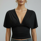 zwarte top met diepe V-hals en aangesloten taille dames