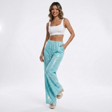 turquoise glitter broek met elastische taille en witte crop top dames