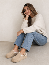 beige gevoerde clogs dames gedragen bij een lichte jeans