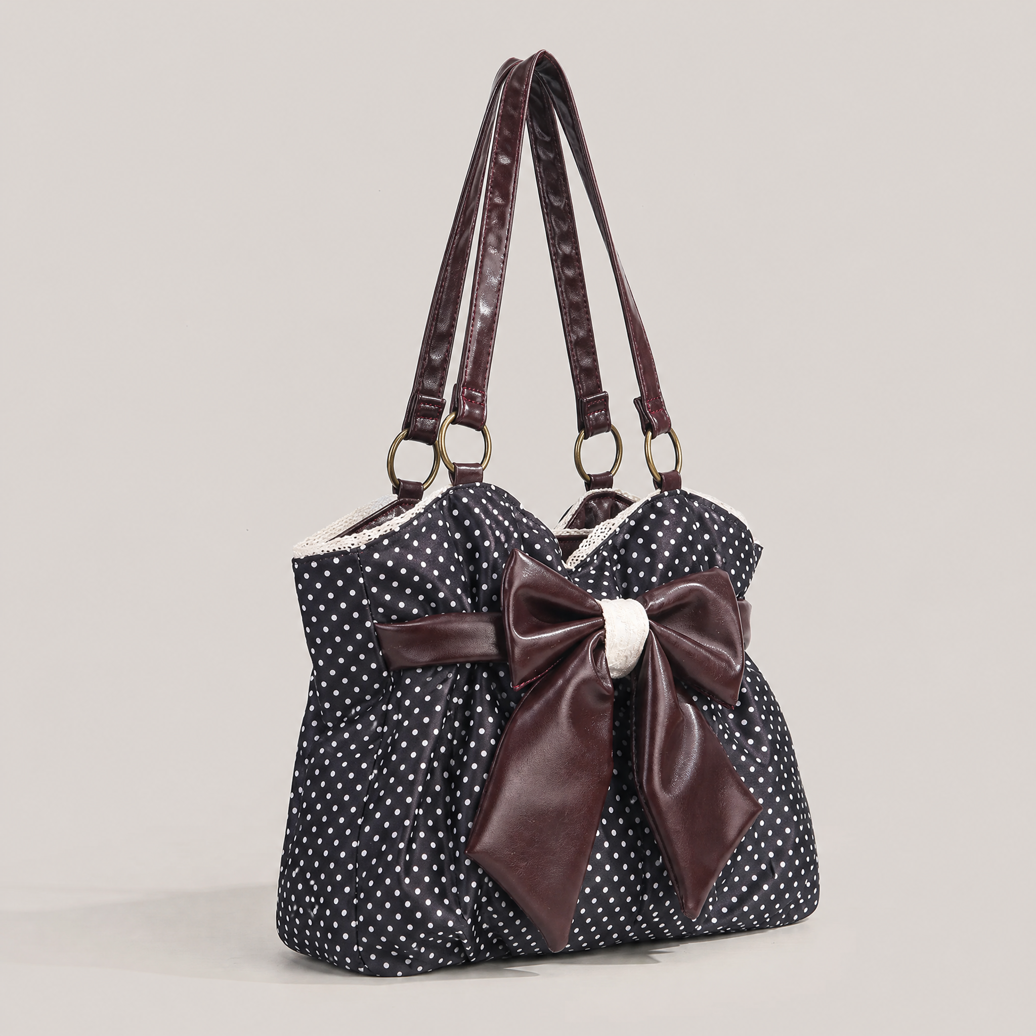 zwarte polkadot schoudertas met bruine strik en kanten detail