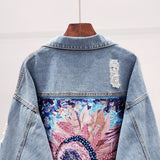 Spijkerjack met glittersteentjes en kunstzinnige patch
